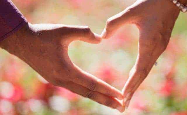 heart shaped hands of man and woman in love