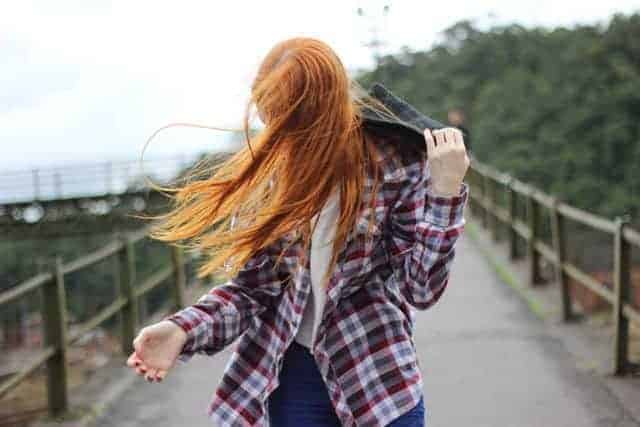 Red Headed Girl walking on Bridge