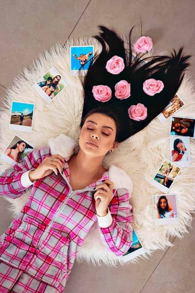 girl lying on floor with pictures all around her daydreaming