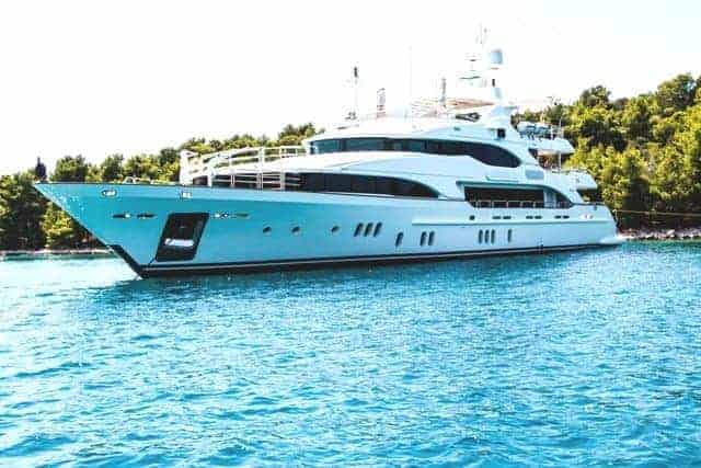 True Wealth 100 Foot Yacht in Clear Blue water