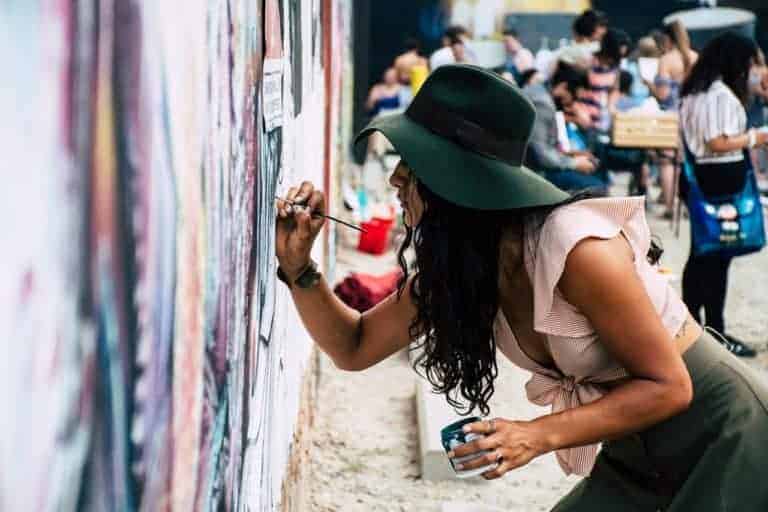 Life Path number three women painting a mural in street